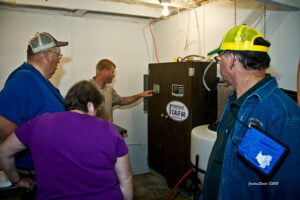 tour group looks at calf feeder