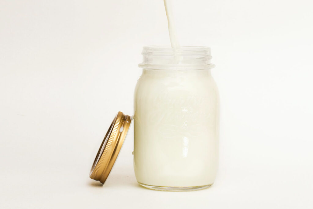 unpasteurized milk poured into a mason jar