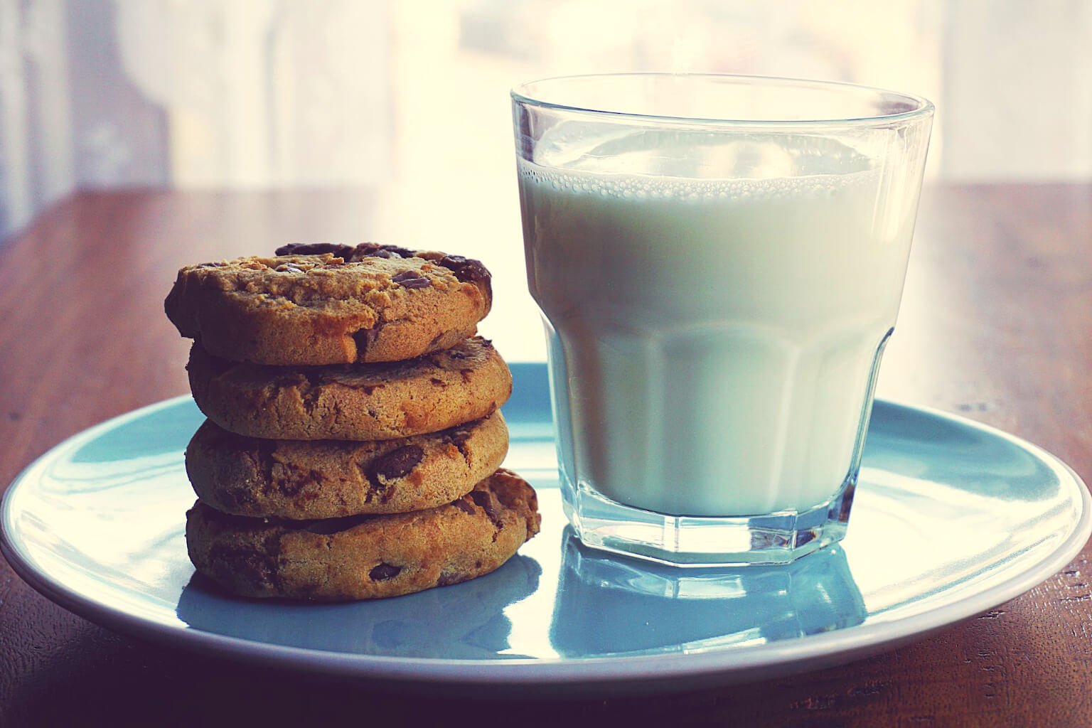 plate of stacked cookies and glass of milk