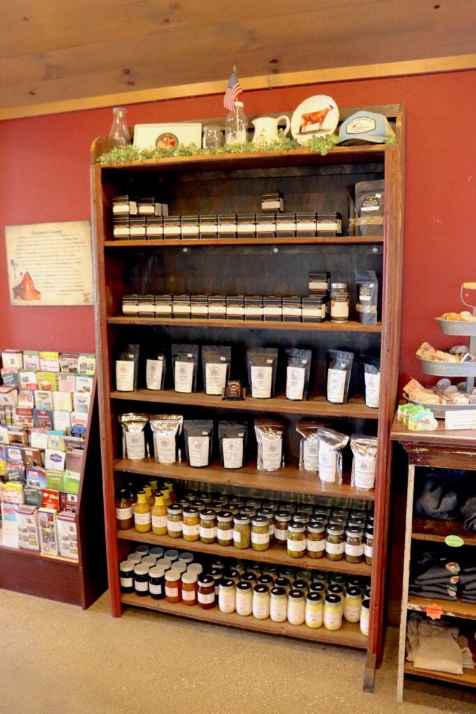 shelf filled with teas, sauces, pickles, and relishes