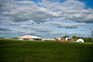 our barn and pasture with big puffy clouds in the sky