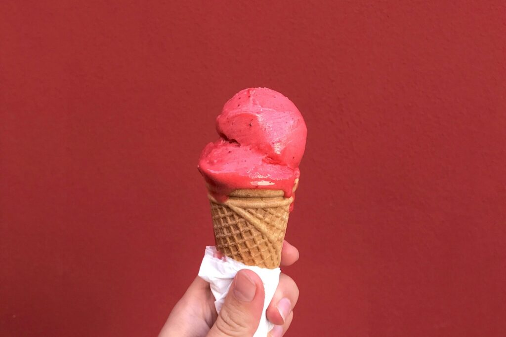 someone holding a gelato in a waffle cone