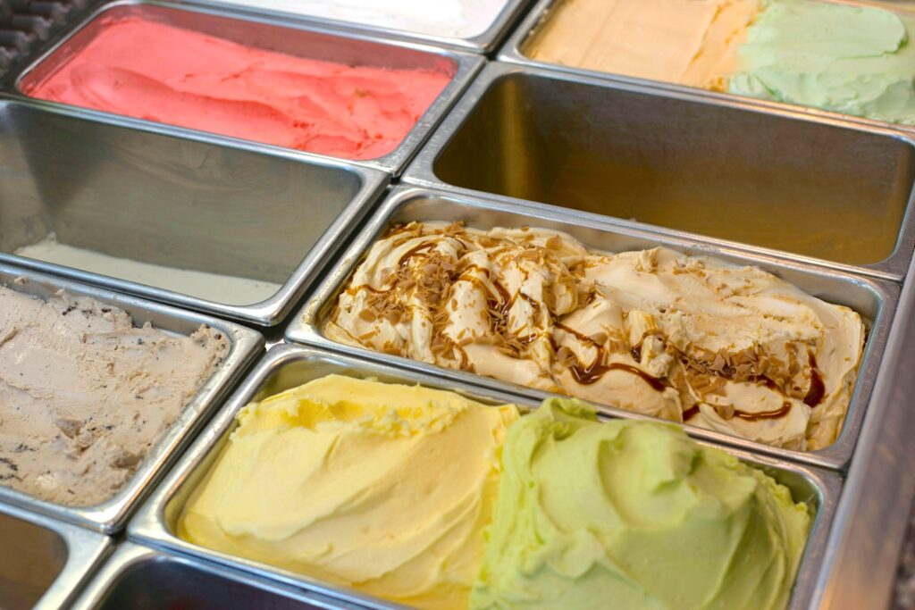 various flavors of gelato displayed in a cooler
