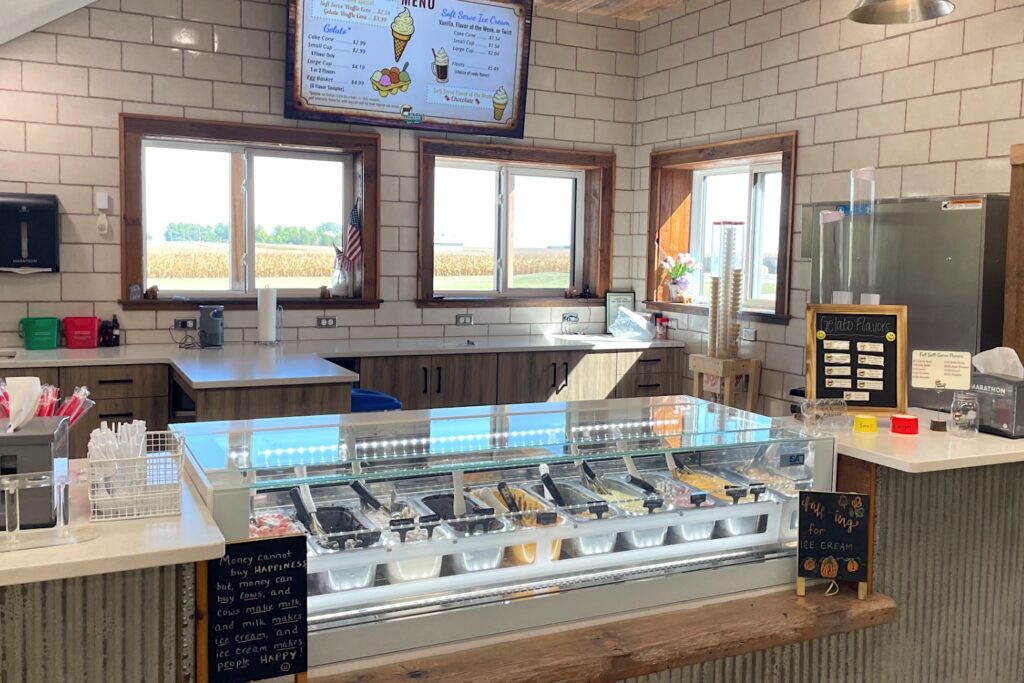 gelato counter with a wide variety of flavors, soft serve ice cream machine, waffle cones and dishes, floats and other frozen dairy treats