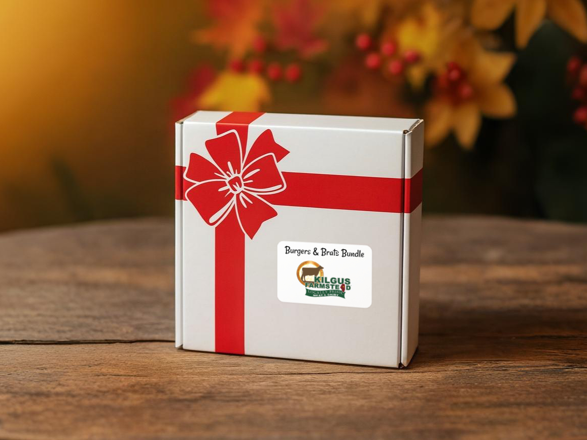 Kilgus Farmstead Holiday Meat & Cheese Baskets and Frozen Meat Bundles holiday gift box with printed ribbon setting on a holiday seasonal table