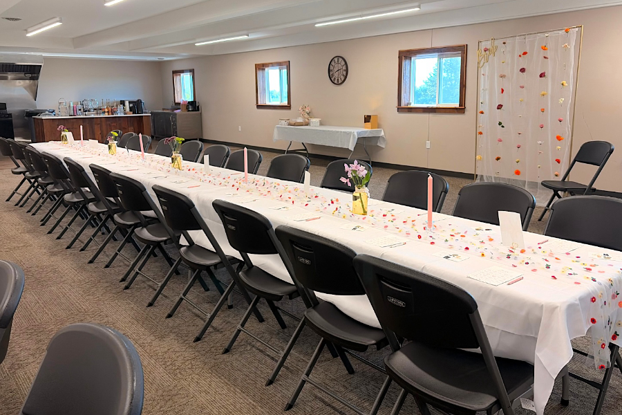 event space setup for celebration with decorations, tables, and chairs